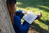A young woman studies the scriptures.