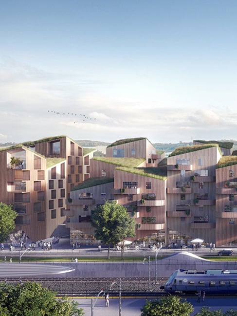 Illustration av moderna trähus med gröna tak och terrasser vid järnväg, med en tågplattform i förgrunden