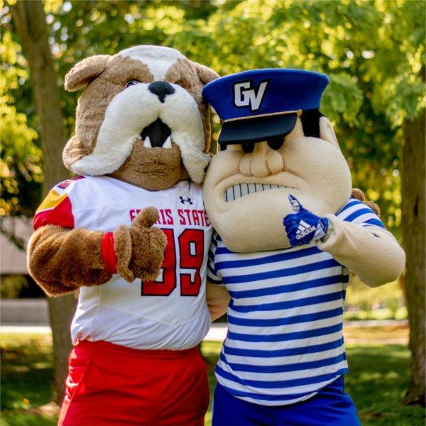 The Ferris State mascot, Brutus the Bulldog, and the Grand Valley mascot, Louie the Laker, flash the thumbs-up hand sign while posing for a photo.